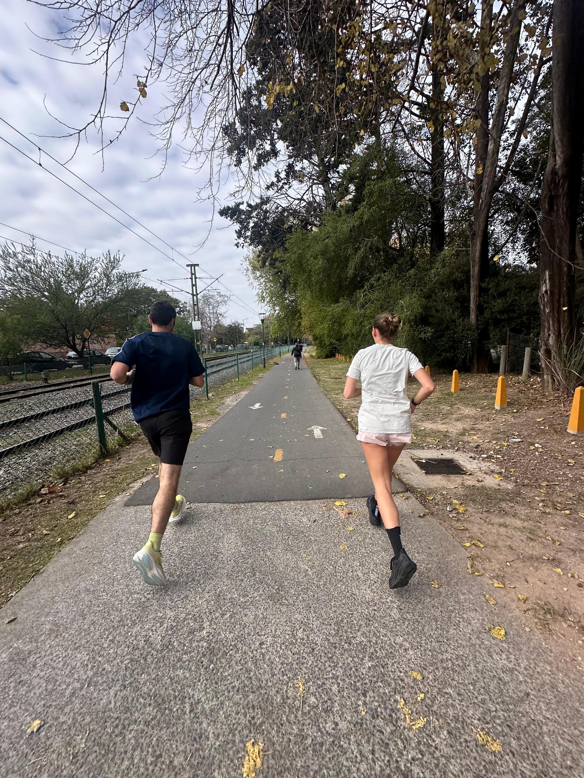 Two employees running together at a corporate sports event